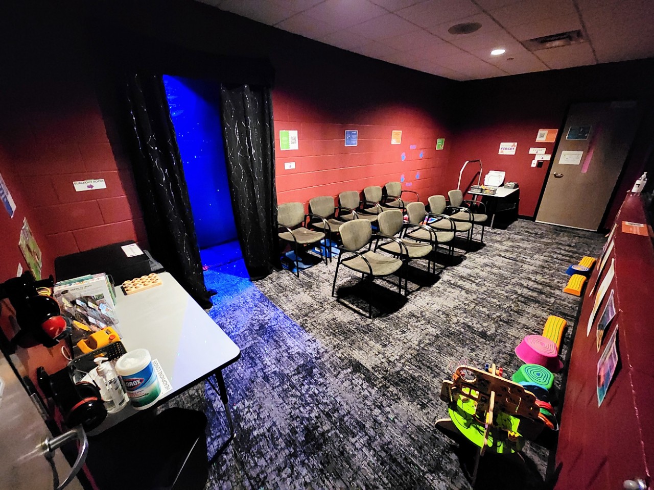 New Sensory Room funded by the Tennessee Arts Commission a room with chairs, low lighting, and some colorful toys and a window where attendees can watch the theater stage