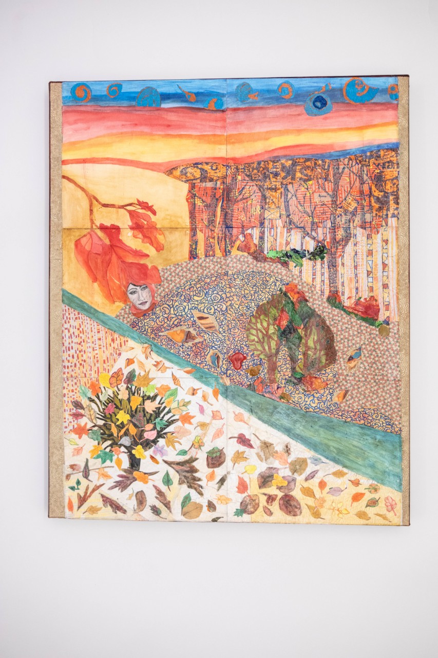 Mother Nature, Fall, 2023 a mixed media piece showing a nature scene of a river cutting across the canvas with leaves, trees and forests on either side; there are different patterns on the canvas and many autumn colors