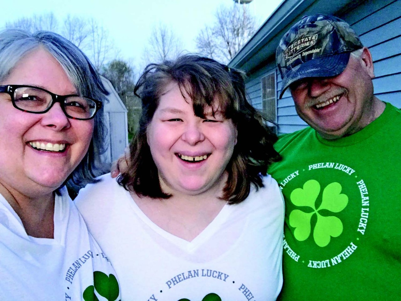 Bonnie Micheli, daughter and husband a lovely, happy photo of author Bonnie with her daughter Nicole and her husband Brian. It is an outdoor shot and all three family members have big smiles on their faces
