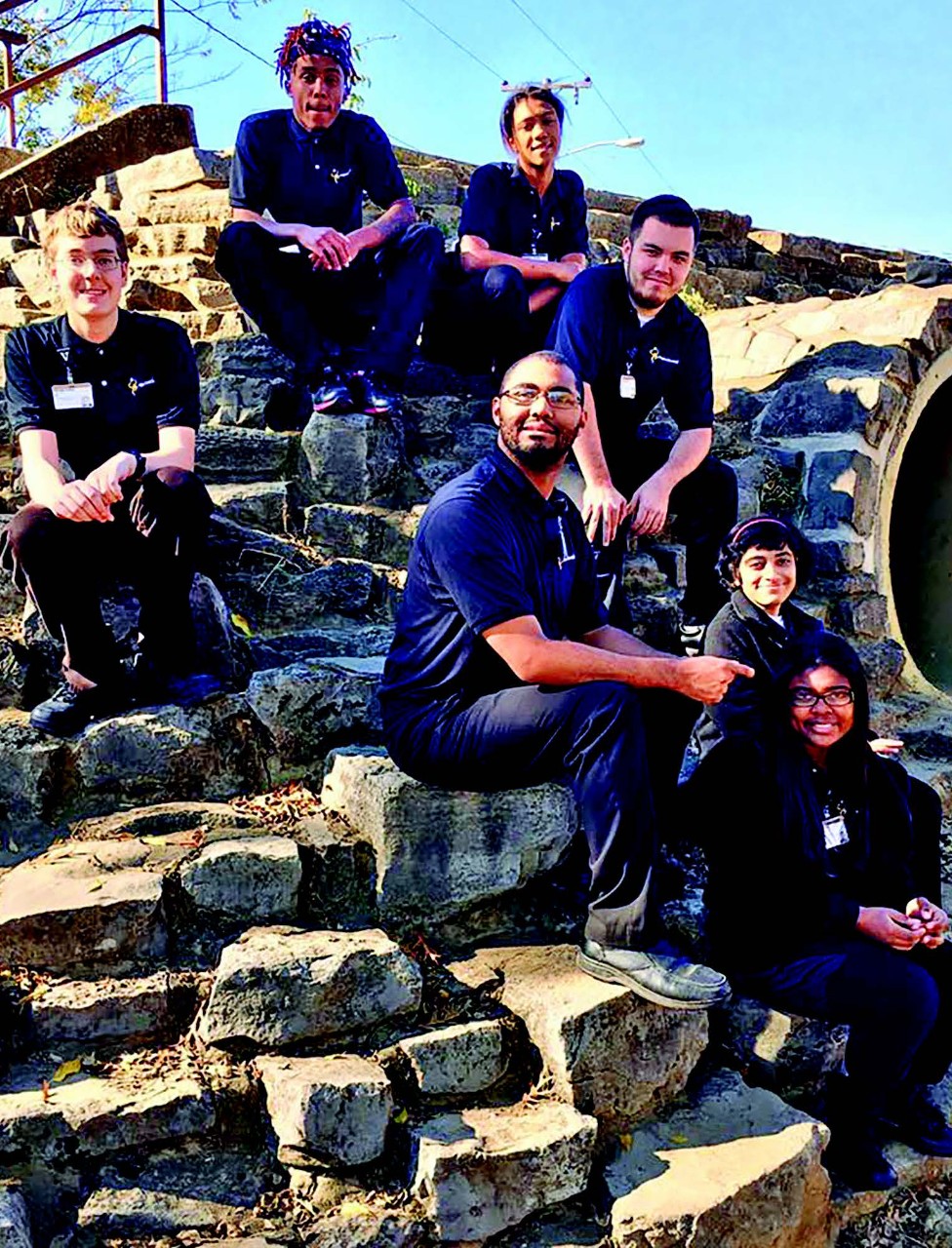 Project SEARCH Vanderbilt Intern Class 2017. Project SEARCH Vanderbilt Intern Class 2017. This is a diverse group of young people, all in dark blue uniforms. They are posing on a curved stone wall.