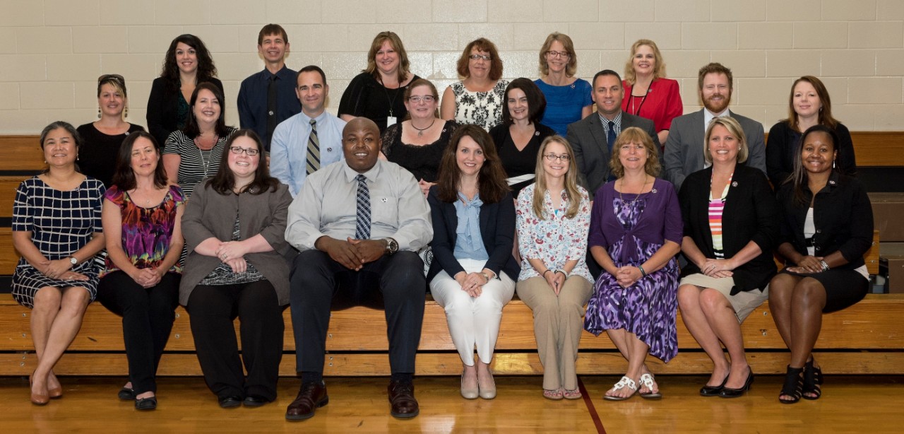 picture of the LAEDS graduating class. It is a large, ethnically diverse group of men and women, posing on bleachers.