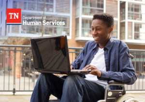 A young man with a physical impairment using a computer outside of a traditional learning environment