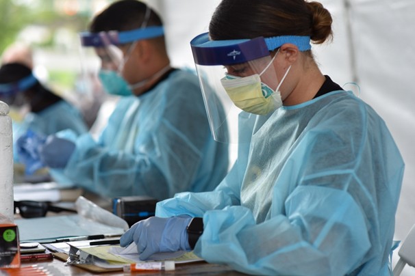 Soldier in personal protective gear working at covid-19 testing site