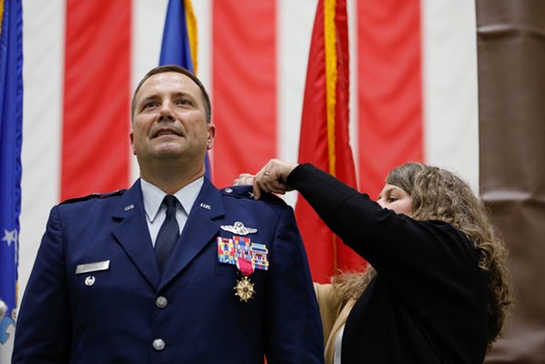 Dawn Wiles, the wife of Brig. Gen. Todd Wiles, fastens new rank onto her husband’s uniform during his promotion ceremony to brigadier general in the Tennessee Air National Guard held at Berry Field Air National Guard Base in Nashville, Nov. 5. (photo by Tech. Sgt. Darrell Hamm) Dawn Wiles, the wife of Brig. Gen. Todd Wiles, fastens new rank onto her husband’s uniform during his promotion ceremony to brigadier general in the Tennessee Air National Guard held at Berry Field Air National Guard Base in Nashville, Nov. 5. (photo by Tech. Sgt. Darrell Hamm)