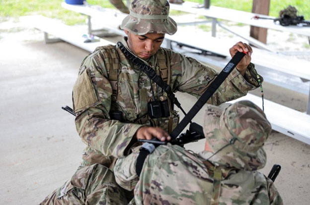 Senior Airman Laurence Rodgers simulates first-aid during the two-week patrol course, Aug. 6-20 held in Lavinia. (Photos by Capt. Kealy Moriarty) Senior Airman Laurence Rodgers simulates first-aid during the two-week patrol course, Aug. 6-20 held in Lavinia. (Photos by Capt. Kealy Moriarty)