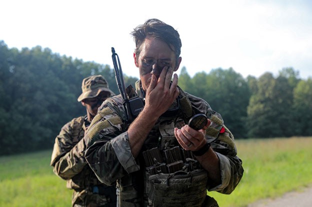 Staff Sgt. Colin Wheeler applies tactical camouflage prior to the squad’s field training exercise during the two-week patrol course, Aug. 6-20, held in Lavinia. (Photos by Capt. Kealy Moriarty) Staff Sgt. Colin Wheeler applies tactical camouflage prior to the squad’s field training exercise during the two-week patrol course, Aug. 6-20, held in Lavinia. (Photos by Capt. Kealy Moriarty)