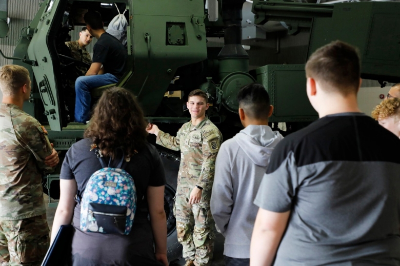 Sgt. Gage Boggess with Chattanooga’s 1-181st Field Artillery Regiment briefs Coffee County Central and Tullahoma High School students on the M-ATV, or Mine-resistant ambush protected All-Terrain Vehicle, during a career day at the Tullahoma National Guard Armory on April 6. (photo by Lt. Col. Marty Malone)