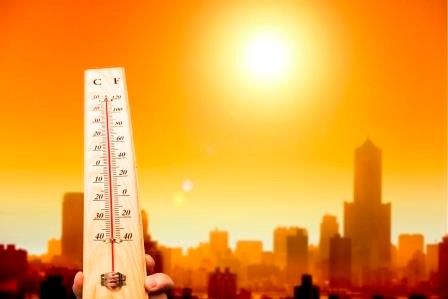 heat wave in the city and hand showing thermometer for high temperature